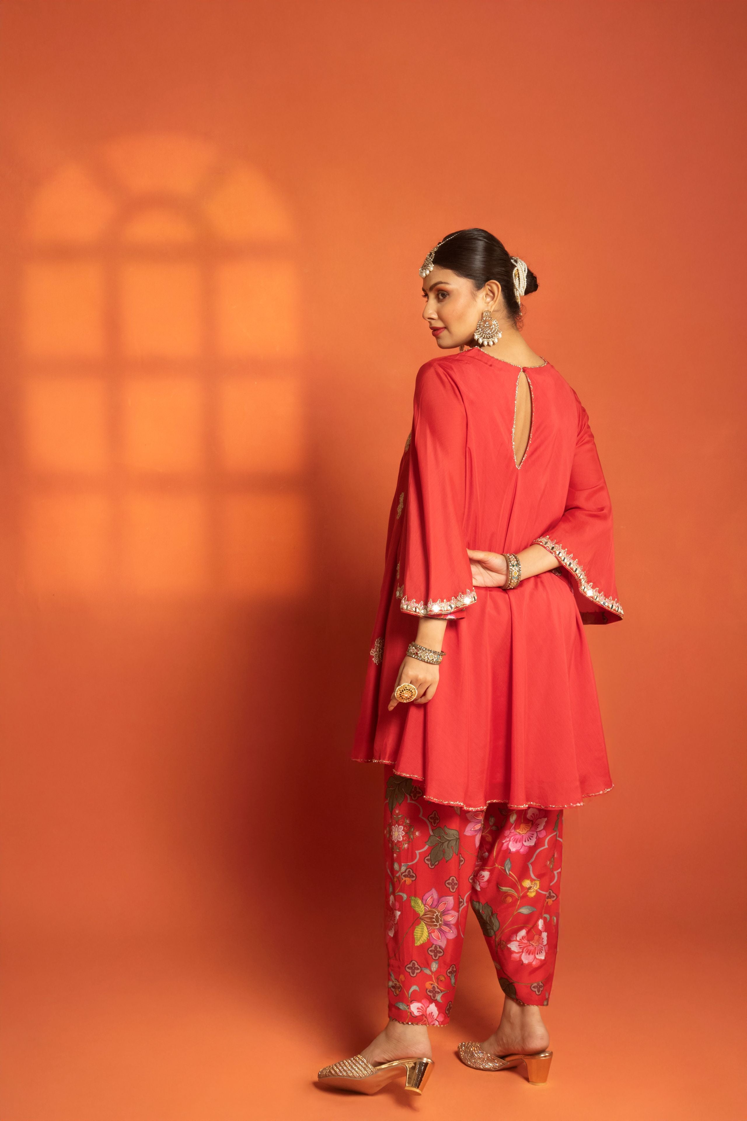Red Short Semi- Anarkali with a heavily Embroidered Neckline, Paired with Floral Printed Salwar Pants & Dupatta