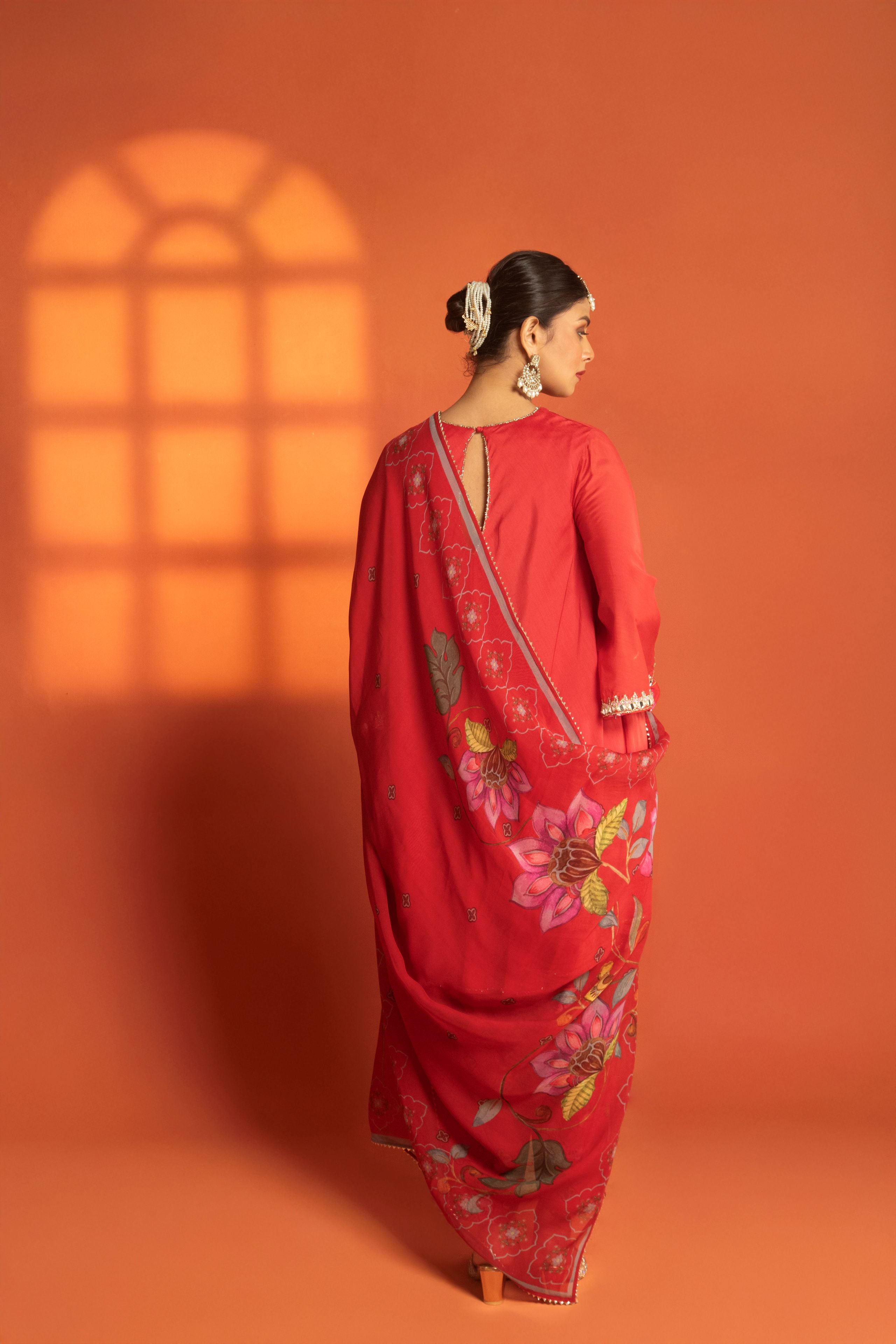 Red Short Semi- Anarkali with a heavily Embroidered Neckline, Paired with Floral Printed Salwar Pants & Dupatta