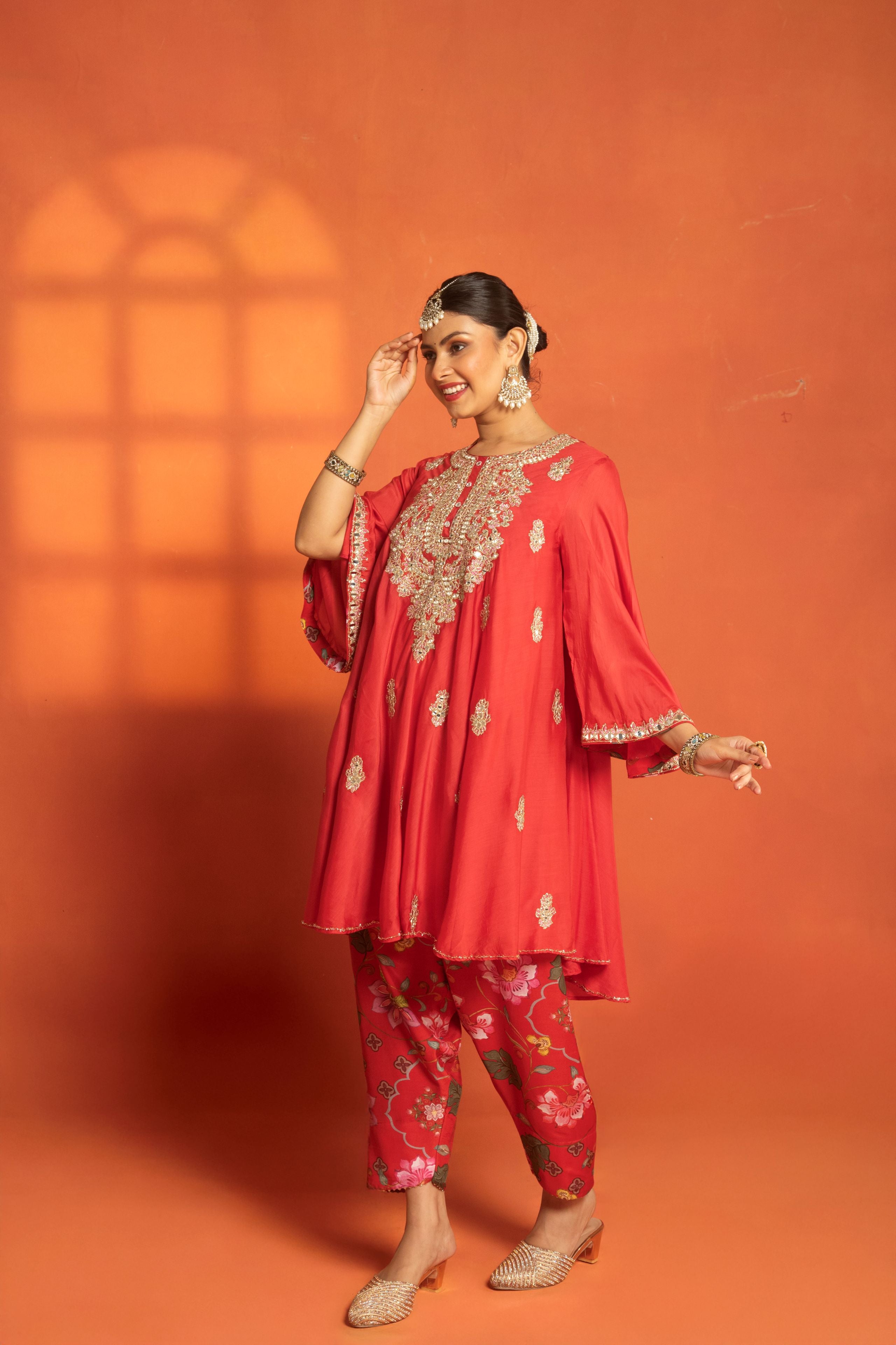 Red Short Semi- Anarkali with a heavily Embroidered Neckline, Paired with Floral Printed Salwar Pants & Dupatta