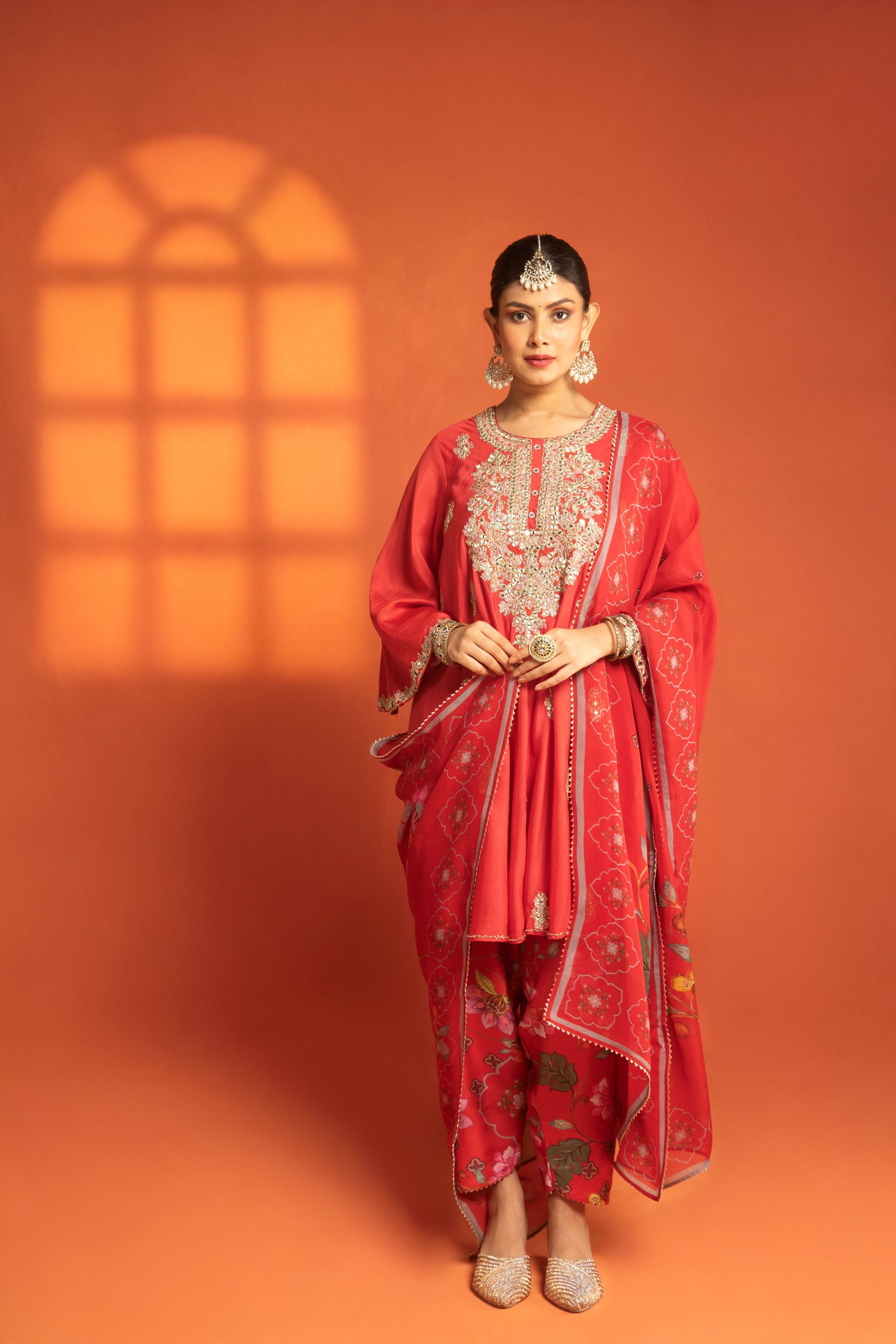 Red Short Semi- Anarkali with a heavily Embroidered Neckline, Paired with Floral Printed Salwar Pants & Dupatta