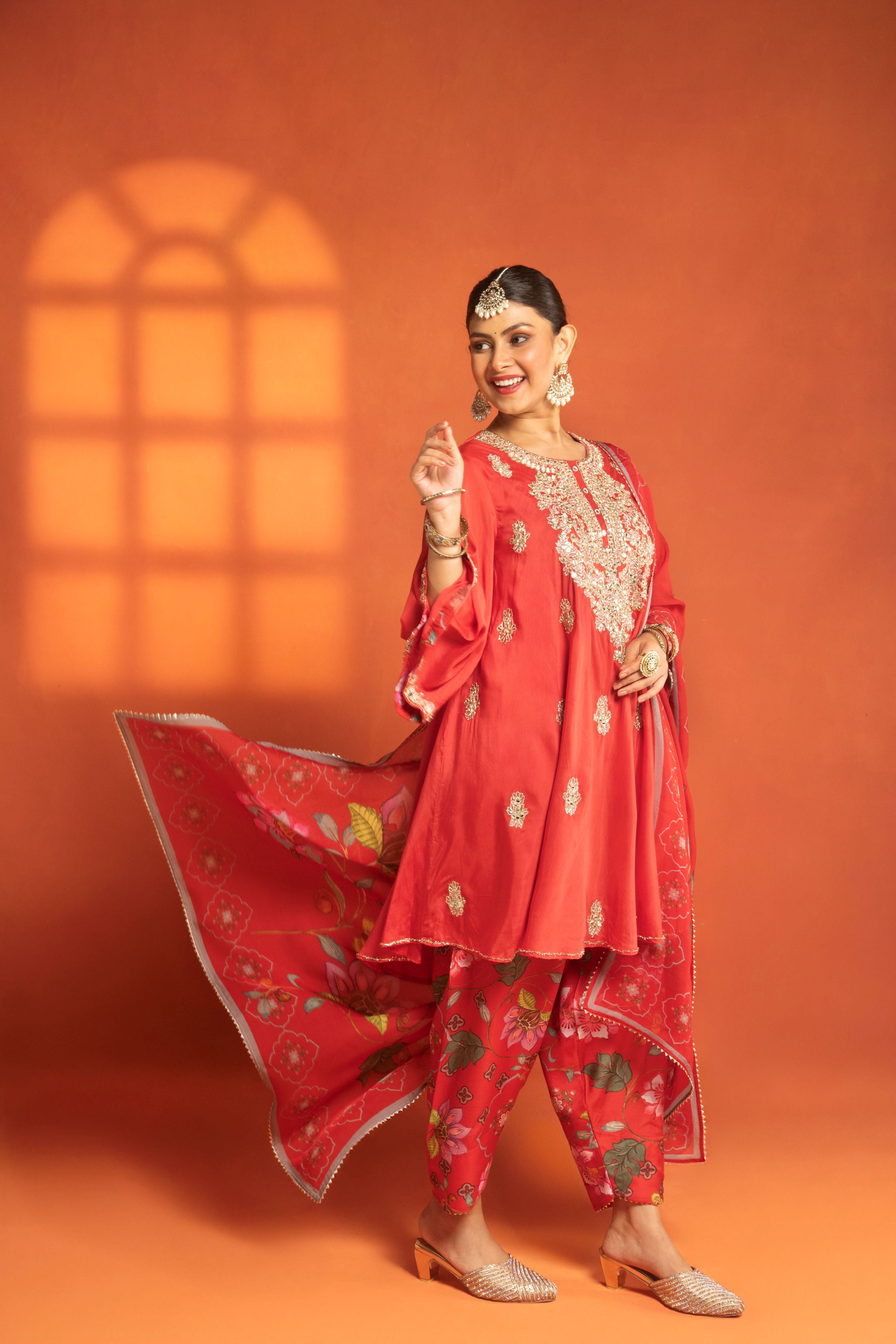 Red Short Semi- Anarkali with a heavily Embroidered Neckline, Paired with Floral Printed Salwar Pants & Dupatta
