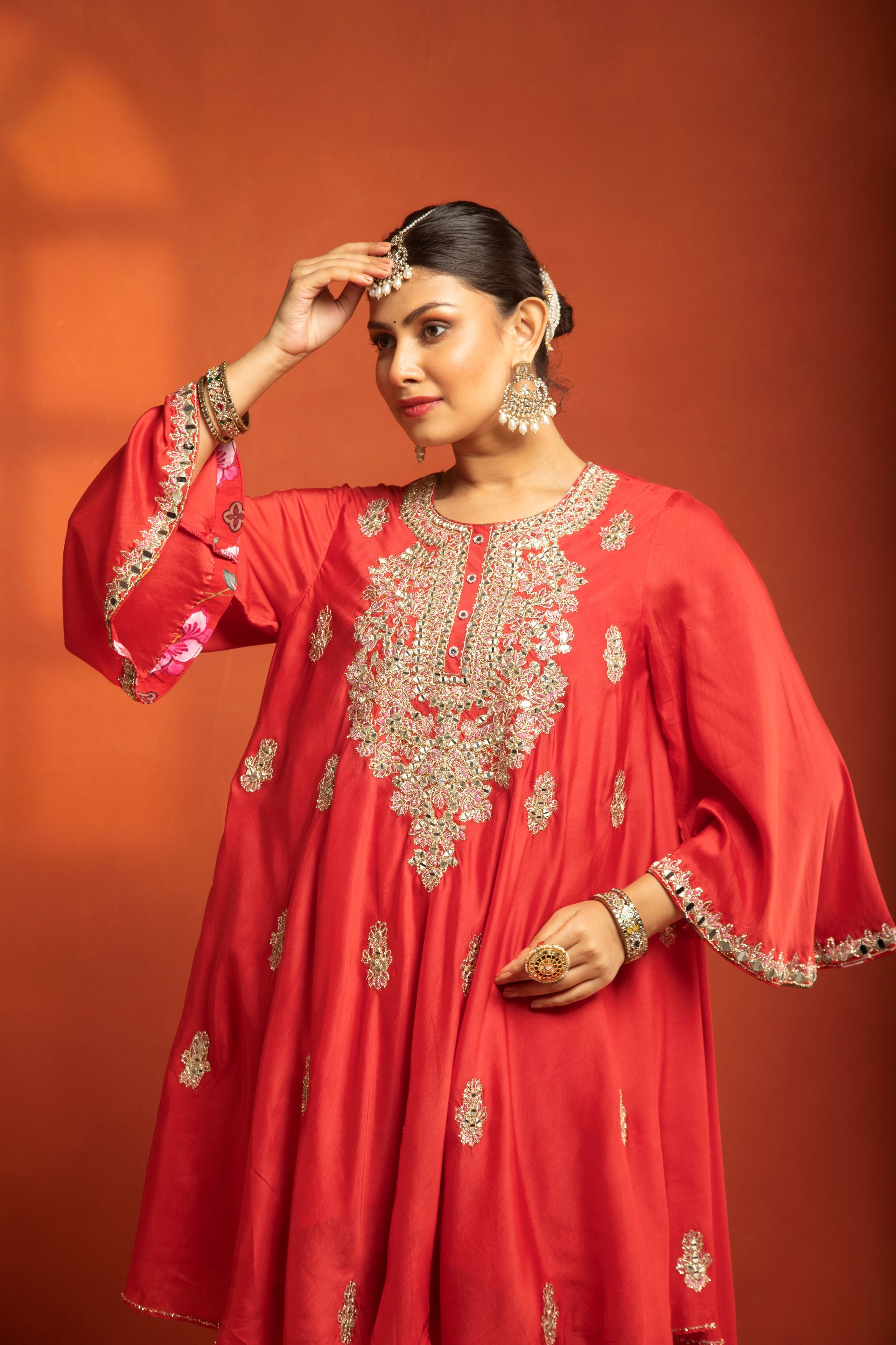 Red Short Semi- Anarkali with a heavily Embroidered Neckline, Paired with Floral Printed Salwar Pants & Dupatta